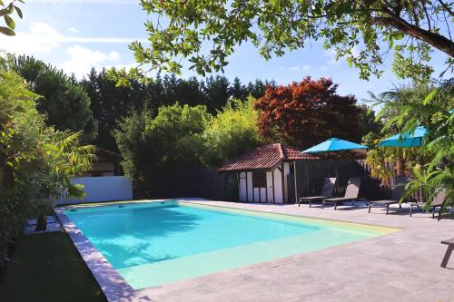 uma piscina num quintal com um gazebo em Domaine La Castilha em Biscarrosse
