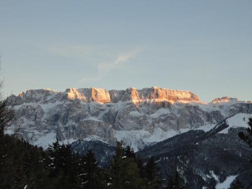 a view of a mountain range with snow on it at Villa Sella in Selva di Val Gardena