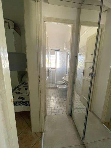 a bathroom with a toilet and a sink and a mirror at Casa Libera in Savelletri di Fasano