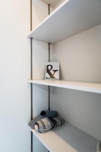 a room with white shelves with a picture on it at HANASTAY花渓居 · 澄（KIYOSI) in Osaka