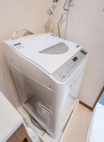 a white washing machine sitting in a room at HANASTAY花渓居 · 澄（KIYOSI) in Osaka