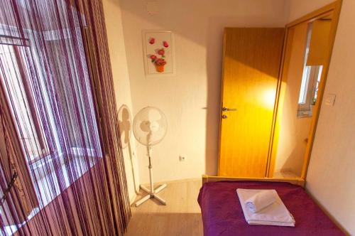 a room with a bed and a mirror and a fan at Casa Laura Cres in Cres