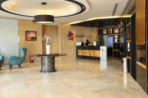 a lobby of a hotel with a table and a counter at Quiet Dreams - King Road Branch in Jeddah