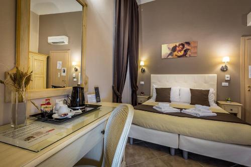 a hotel room with a bed and a desk with a counter top at Sognando Firenze in Florence