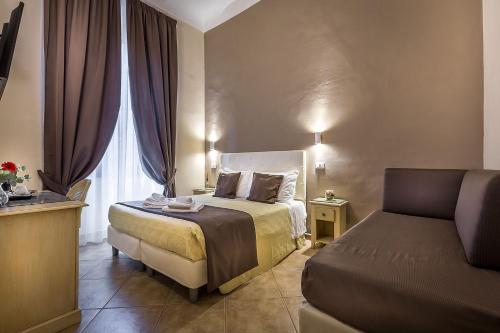 a hotel room with a bed and a window at Sognando Firenze in Florence