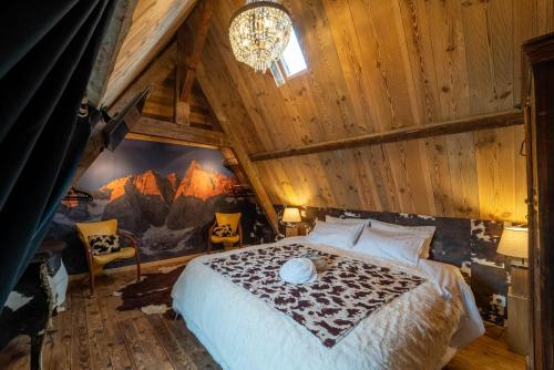 a bedroom with a bed in a wooden ceiling at A Nouste chambres d'hotes et gite ONLY ADULTS in Campan