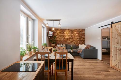 a living room with a table and chairs and a couch at Apartament Łysa Góra in Szklarska Poręba