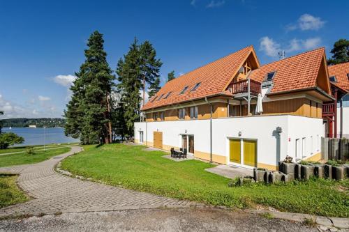 a large white building with a red roof at Riviera Lipno 503 - 15 in Lipno nad Vltavou