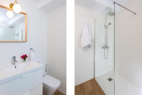 a white bathroom with a sink and a shower at Plaza España, acogedor apartamento con patio by OUTIN in Seville