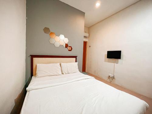 a bedroom with a white bed and a tv at N9 Business Hotel Sdn Bhd in Nilai
