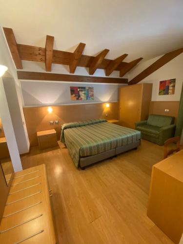 a bedroom with a bed and a couch in it at Al Brenta in Levico Terme