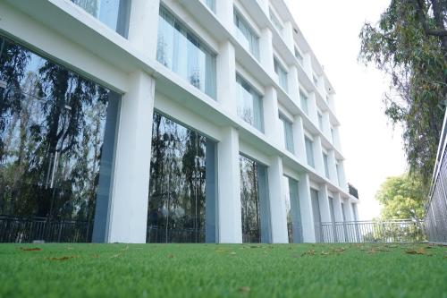 a large white building with grass in front of it at HOTEL MAKHAN VIHAR in Ambikāpur