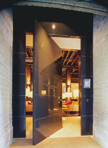 a glass door leading into a room with beds at Establishment Hotel in Sydney
