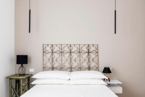 a bedroom with a large white bed with white pillows at LUVI - Pasubio in Milan
