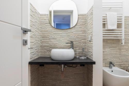 a bathroom with a sink and a mirror at LUVI - Pasubio in Milan