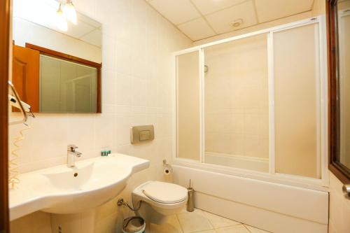 a bathroom with a sink and a toilet and a shower at Gocek Unlu Hotel in Göcek