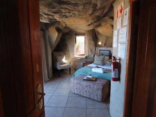 a bedroom with a bed in a cave room at Kagga Kamma Nature Reserve in Lochlynne