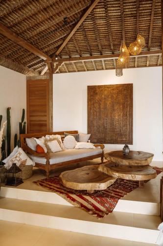a living room with a couch and coffee tables at Gypsea Bali in Uluwatu