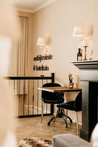 a dining room with a table and two chairs at Hotel Janssen in Valkenburg