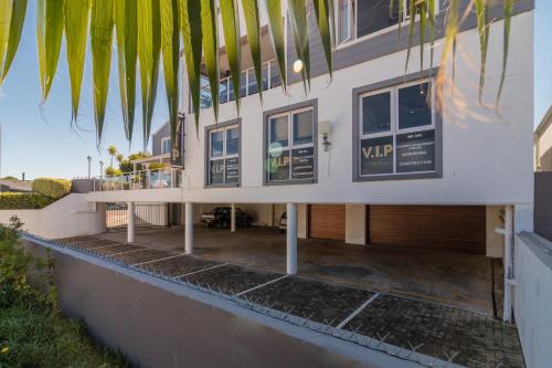 a building with a porch and a patio at Waterfront Delight in Knysna