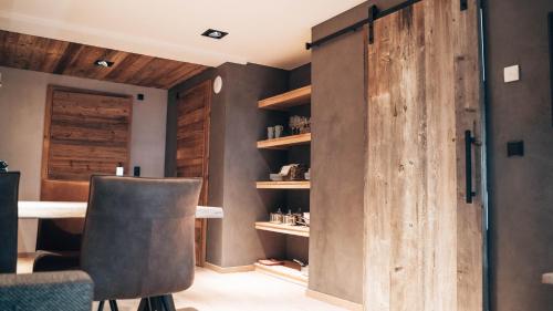 a room with a wooden door and a table and chairs at Mountain See Lodge in See