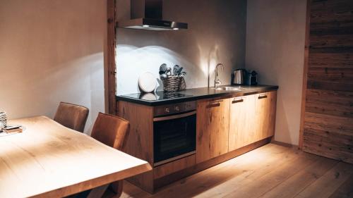 a kitchen with a sink and a table with chairs at Mountain See Lodge in See