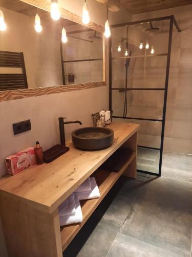 a bathroom with a sink on a wooden counter at Mountain See Lodge in See
