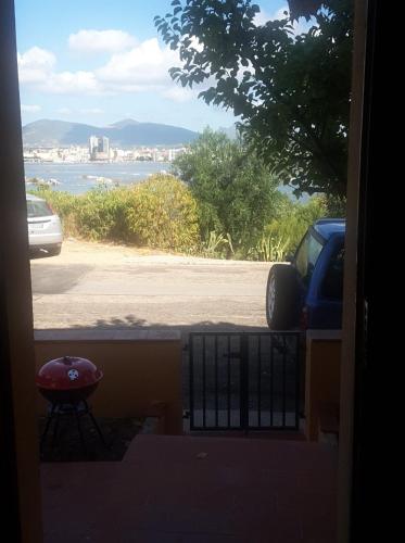 a view from a door of a parking lot with a car at Appartamento Olbia Panoramica Mare in Olbia