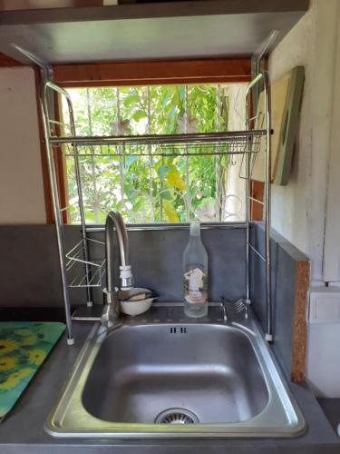 a sink in a tiny kitchen with a window at Gîte Trinacria in Breil-sur-Roya