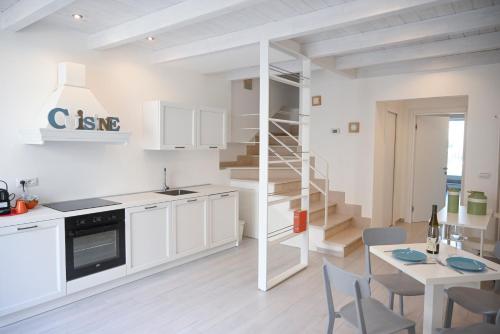 a kitchen with a staircase and a table and chairs at Il b&b di Alice in Monopoli