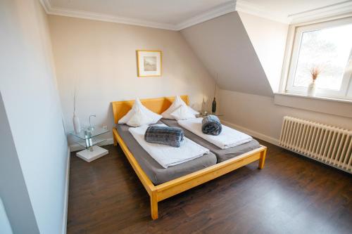 ein Schlafzimmer mit einem Bett mit zwei Kissen darauf in der Unterkunft Ferienwohnung Nr. 9 in Borkum