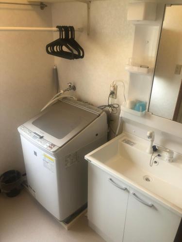 a small bathroom with a sink and a mirror at 今市STAY - NIKKO private house rental only 5 min to station in Nikko
