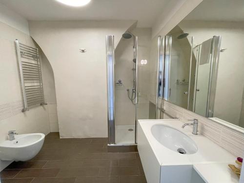 a white bathroom with a sink and a shower at Il b&b di Alice in Monopoli