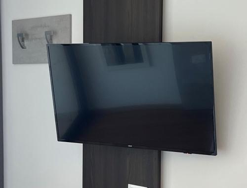a flat screen tv hanging on a wall at Wind Hotel in Malcesine