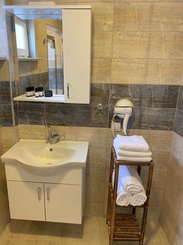 a bathroom with a sink and a mirror at Well Hotel Edirne in Edirne