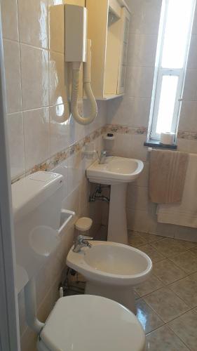 a bathroom with a toilet and a sink at B&B Casa Michele in Taormina