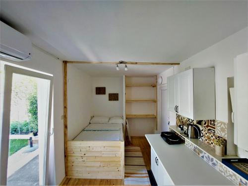 a small room with a bed and a kitchen at Studio apartment Murter Center in Murter