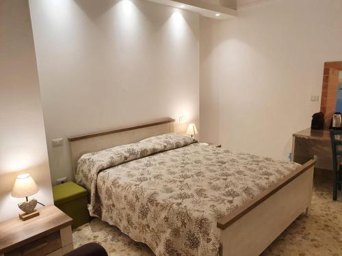 a bedroom with a bed and a table with a lamp at Stella Maris in Conversano