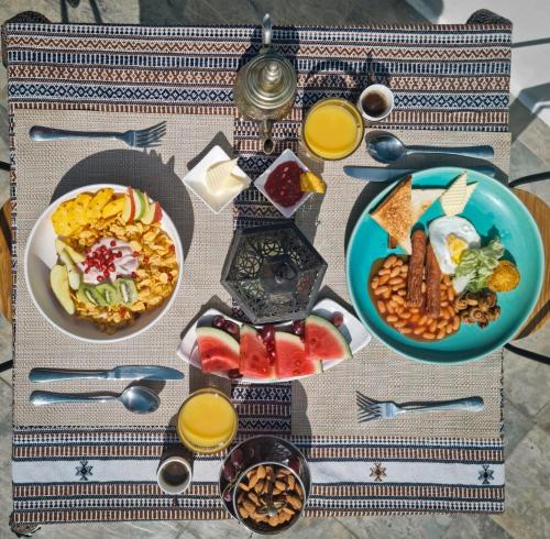 a table topped with plates of food and drinks at Lea Spa Hotel in Maafushi