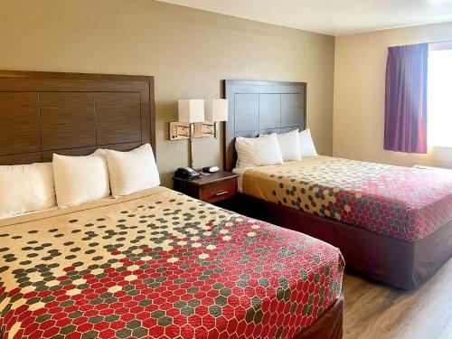 a hotel room with two beds in a room at Econo Lodge Inn & Suites Corning Travel Center in Corning