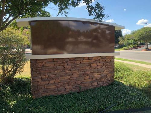 a large screen on top of a brick wall at Sonesta ES Suites San Antonio Northwest Medical Center in San Antonio