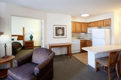a kitchen and living room with a couch and a table at Sonesta ES Suites San Antonio Northwest Medical Center in San Antonio