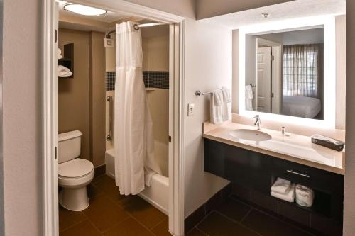 a bathroom with a sink and a toilet and a mirror at Sonesta ES Suites San Antonio Northwest Medical Center in San Antonio