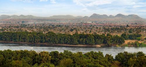 a river with trees and mountains in the background at Radisson Blu Hotel, Juba in Juba