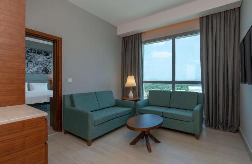 a living room with two chairs and a table at Radisson Blu Hotel, Juba in Juba