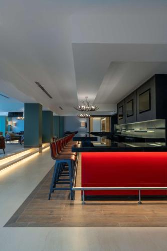 a living room with a red couch and chairs at Radisson Blu Hotel, Juba in Juba