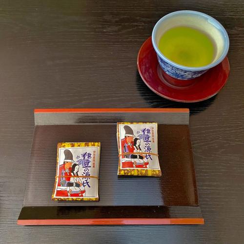 a cup of tea sitting next to a plate of food at Honjin in Izunokuni