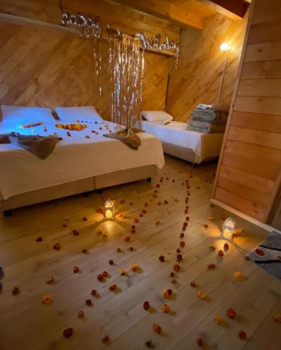 a room with two beds and flowers on the floor at Guesthouse Prrockaj Theth in Theth