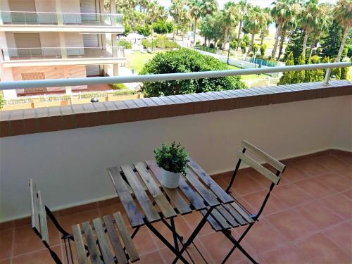 a balcony with a wooden table and two chairs at ACV - Vistamar III-1ª línea planta 2 Frontal in Oropesa del Mar
