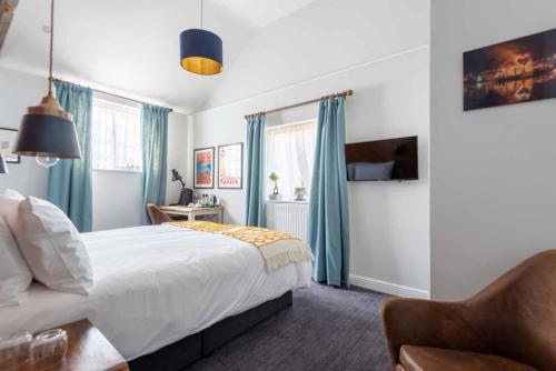 a bedroom with a bed and a chair at The Elm, Abbots Ripton in Abbots Ripton